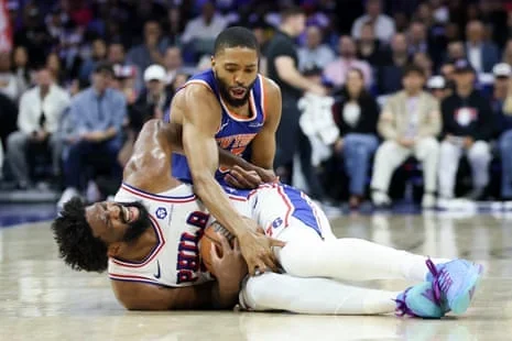 Mikal Bridges and Joel Embiid wrestle for a loose ball during the Knicks’ sweep of the 76ers