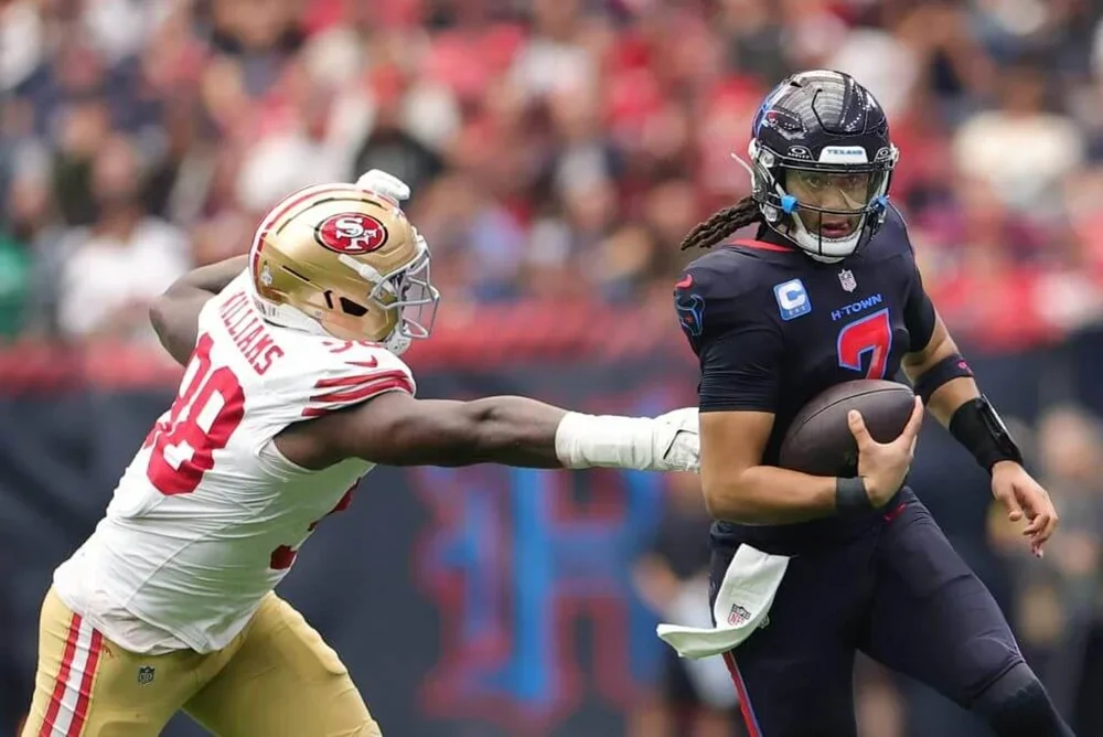Mykel Williams of the San Francisco 49ers pursues Houston Texans quarterback C.J. Stroud.